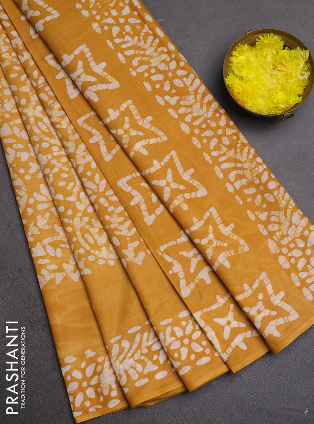 Batik cotton saree mustard yellow with allover prints and batik printed border
