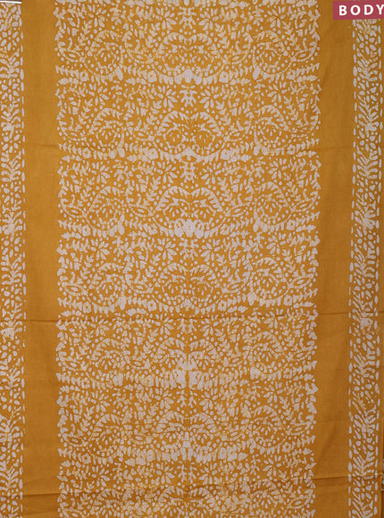 Batik cotton saree mustard yellow with allover prints and batik printed border