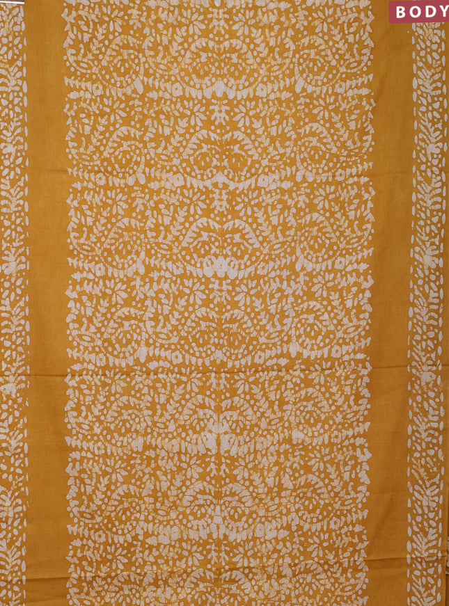 Batik cotton saree mustard yellow with allover prints and batik printed border
