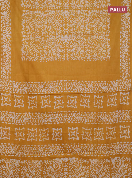 Batik cotton saree mustard yellow with allover prints and batik printed border