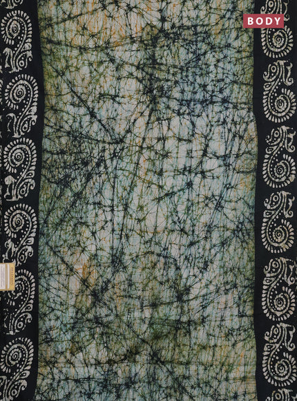 Batik cotton saree bottle green with allover prints and batik printed border