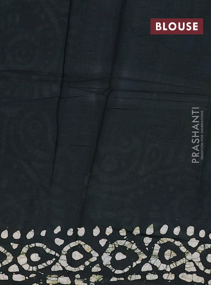 Batik cotton saree bottle green with allover prints and batik printed border