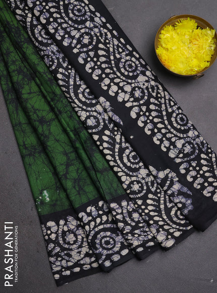 Batik cotton saree bottle green and black with allover prints and batik printed border