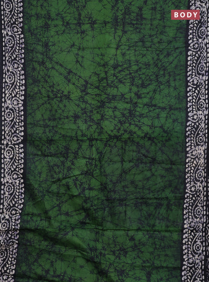 Batik cotton saree bottle green and black with allover prints and batik printed border