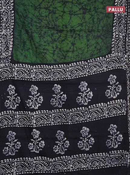 Batik cotton saree bottle green and black with allover prints and batik printed border
