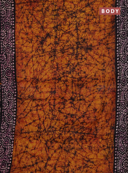 Batik cotton saree dark mustard and jamun shade with allover prints and batik printed border