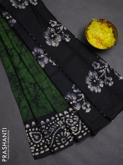 Batik cotton saree bottle green and black with allover prints and batik printed border