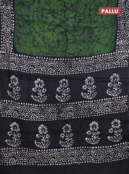 Batik cotton saree bottle green and black with allover prints and batik printed border