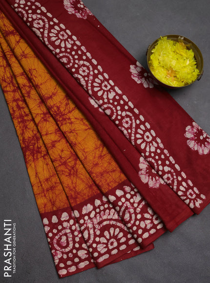 Batik cotton saree mustard yellow and red with allover prints and batik printed border