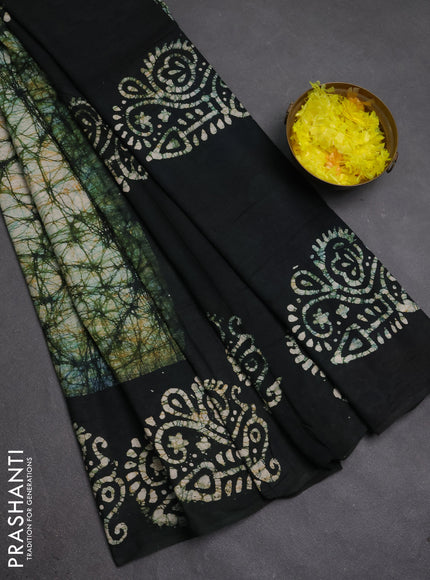 Batik cotton saree bottle green with allover prints and batik printed border