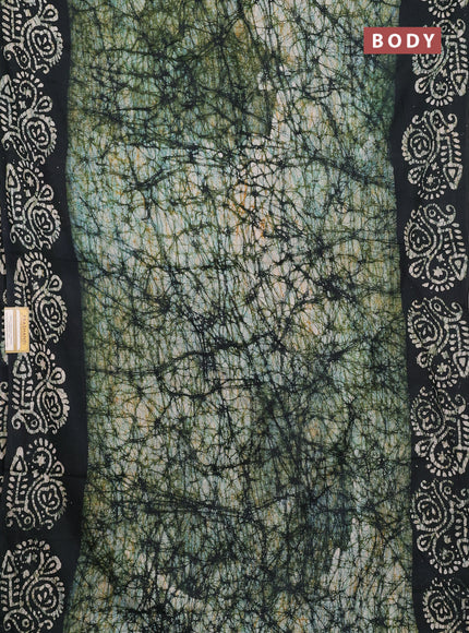 Batik cotton saree bottle green with allover prints and batik printed border