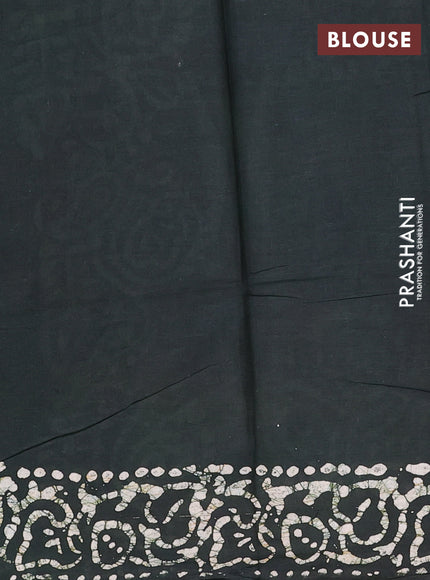 Batik cotton saree bottle green with allover prints and batik printed border