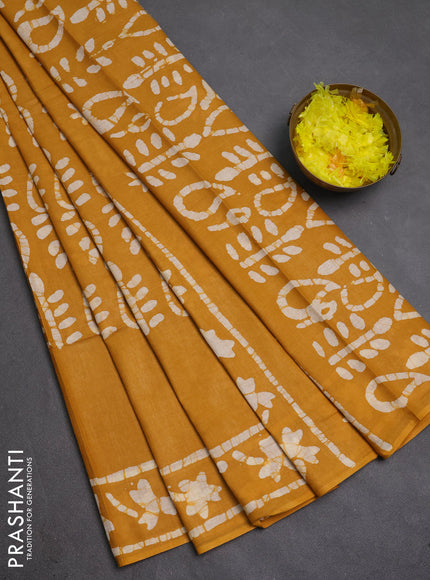 Batik cotton saree mustard yellow with allover prints and batik printed border
