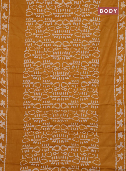 Batik cotton saree mustard yellow with allover prints and batik printed border