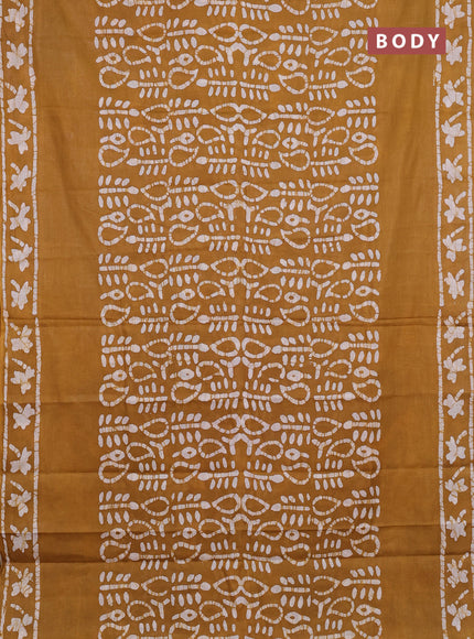 Batik cotton saree mustard yellow with allover prints and batik printed border