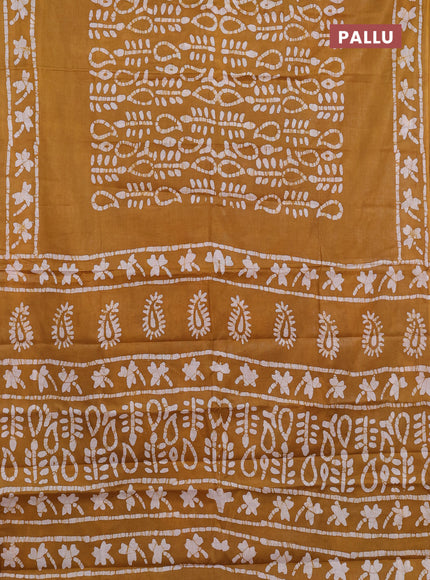 Batik cotton saree mustard yellow with allover prints and batik printed border