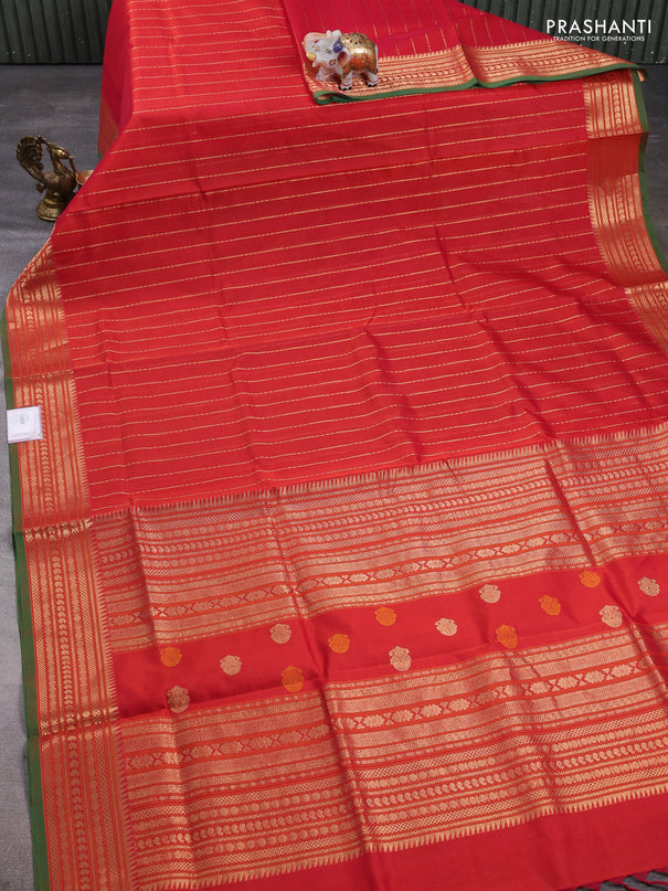 Kanchipuram silk cotton saree dual shade of rustic orange and green with allover zari weaves and zari woven border