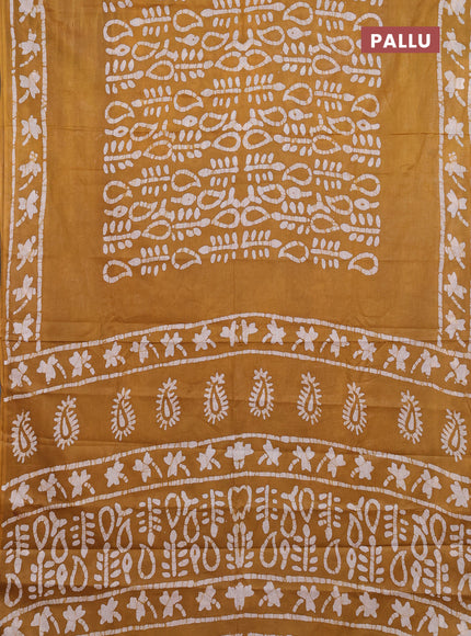 Batik cotton saree mustard yellow with allover prints and batik printed border