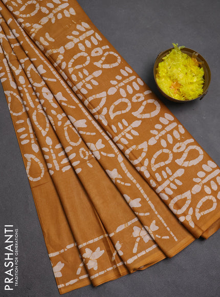 Batik cotton saree mustard yellow with allover prints and batik printed border
