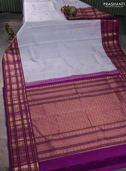 Pure kanchipuram silk saree teal shade and purple with annam & rudhraksha zari woven buttas and long zari woven peacock border