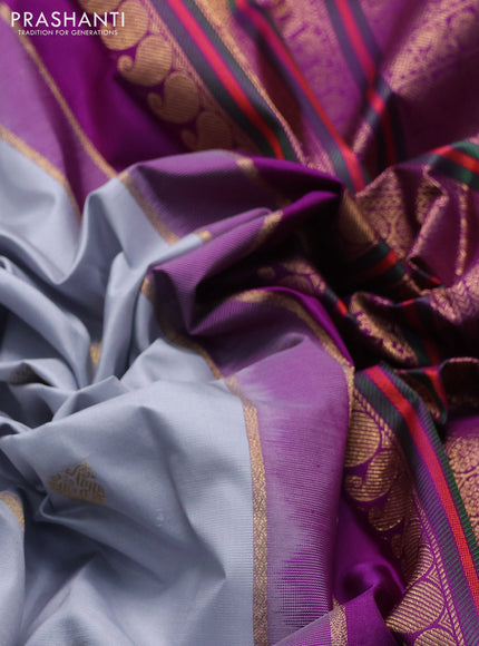 Pure kanchipuram silk saree teal shade and purple with annam & rudhraksha zari woven buttas and long zari woven peacock border