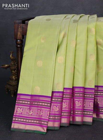 Pure kanchipuram silk saree pista green and purple with annam & rudhraksha zari woven buttas and zari woven peacock design border