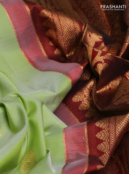 Pure kanchipuram silk saree pista green and deep maroon with annam zari woven buttas and zari woven korvai border
