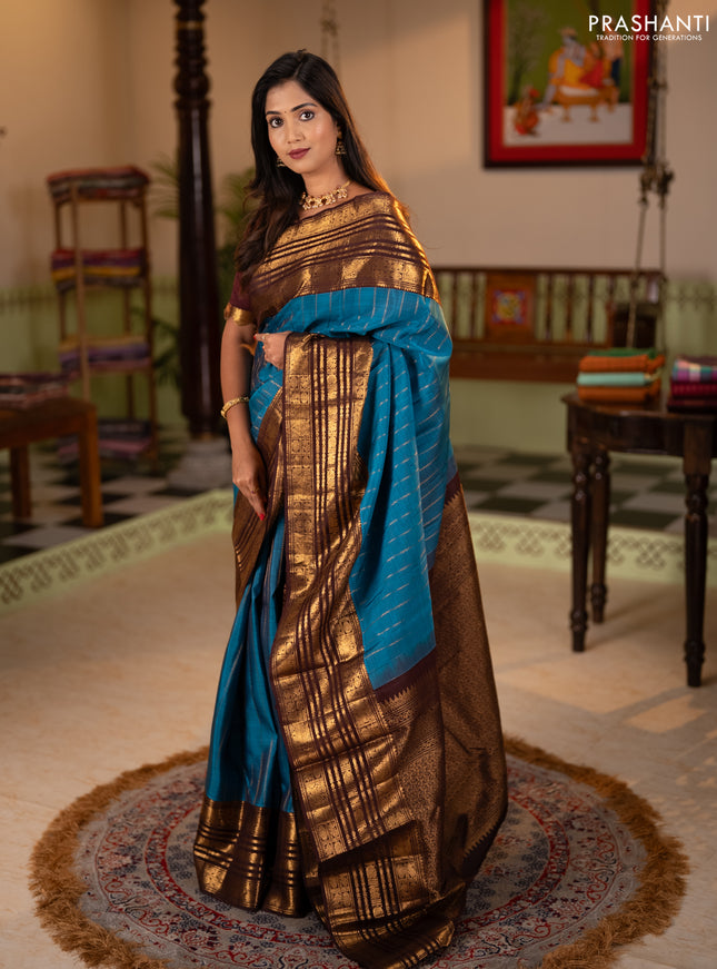 Pure kanchipuram silk saree blue and coffee brown with allover zari stripe pattern and long zari woven border
