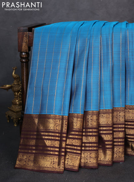 Pure kanchipuram silk saree blue and coffee brown with allover zari stripe pattern and long zari woven border
