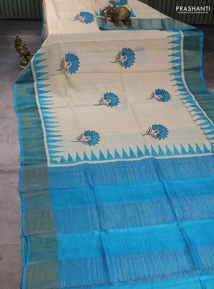 Pure tussar silk saree beige and cs blue with floral butta prints and temple design zari woven border