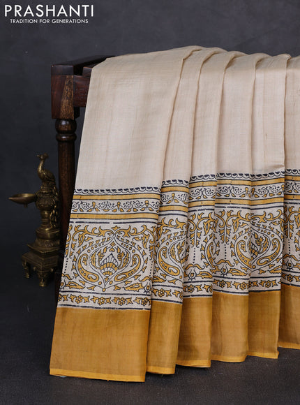 Pure tussar silk saree beige and mustard yellow with plain body and long printed zari woven border