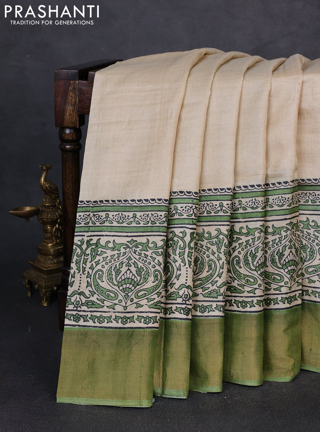 Pure tussar silk saree beige and light green with plain body and long printed zari woven border