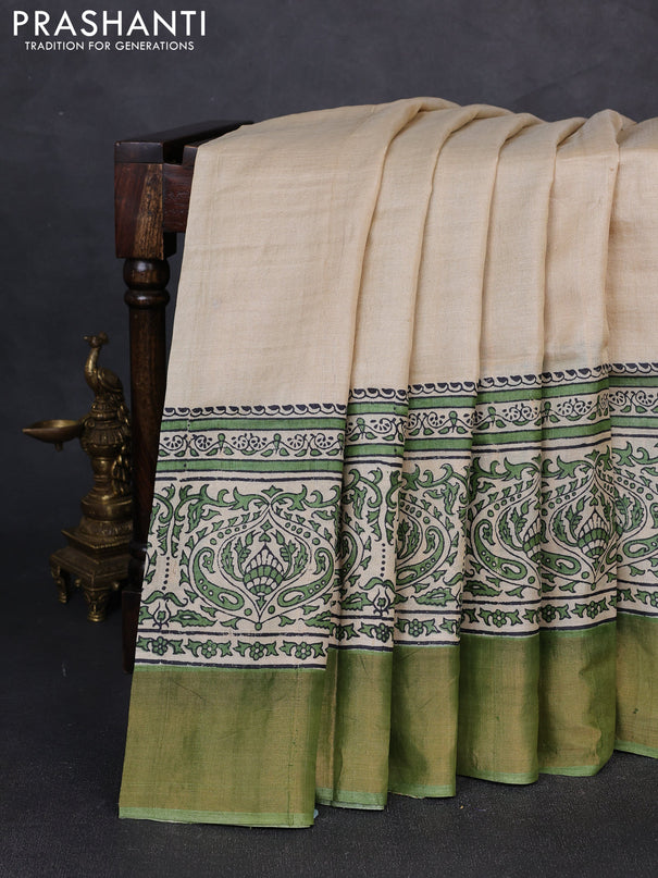 Pure tussar silk saree beige and light green with plain body and long printed zari woven border