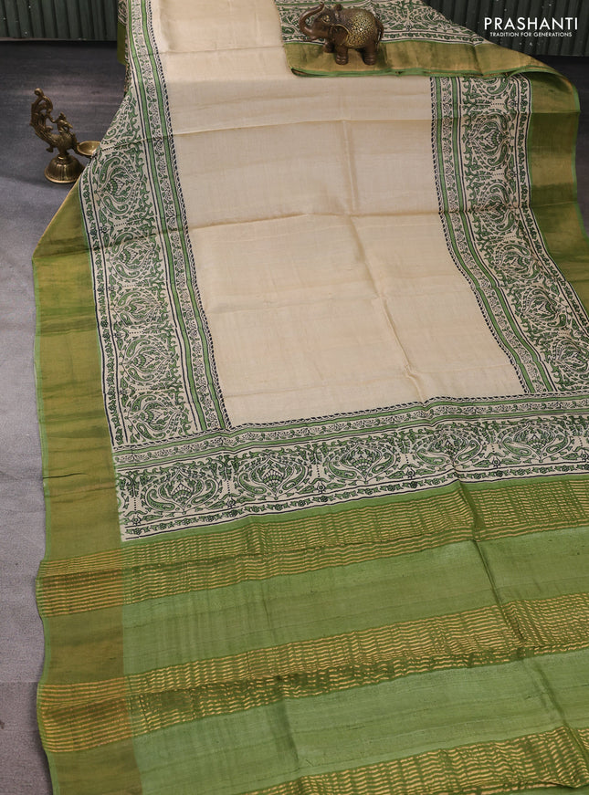 Pure tussar silk saree beige and light green with plain body and long printed zari woven border
