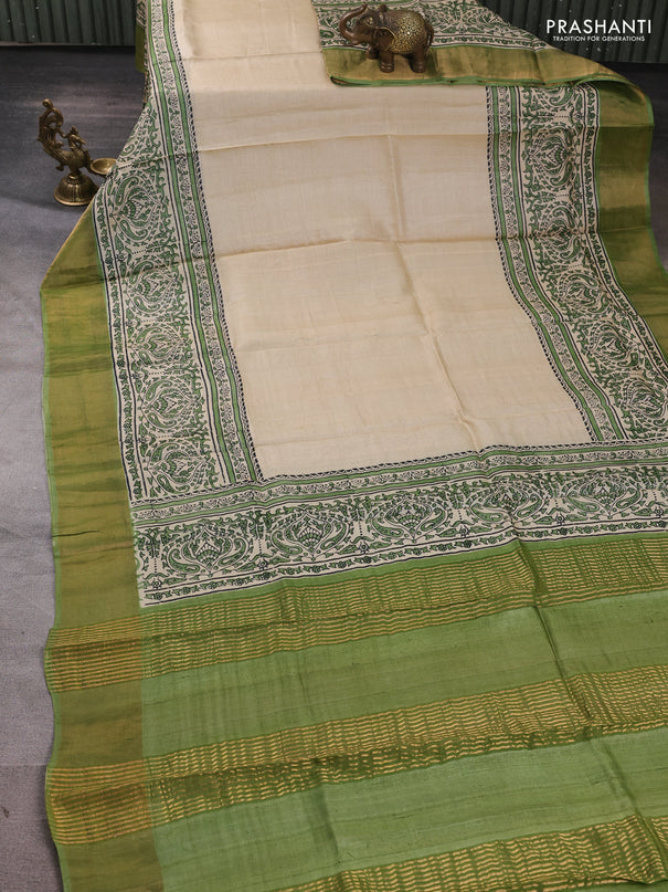Pure tussar silk saree beige and light green with plain body and long printed zari woven border