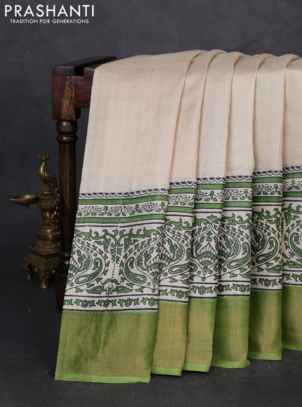 Pure tussar silk saree beige and green with plain body and long printed zari woven border