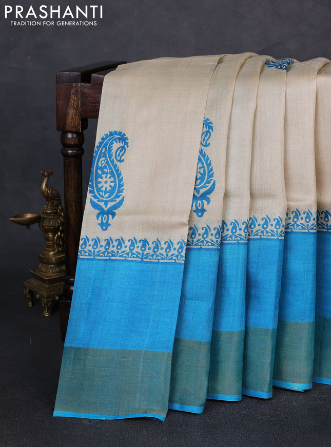Pure tussar silk saree beige and cs blue with paisley butta prints and long simple zari woven border