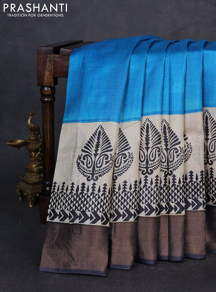 Pure tussar silk saree cs blue and beige black with plain body and long printed zari woven border