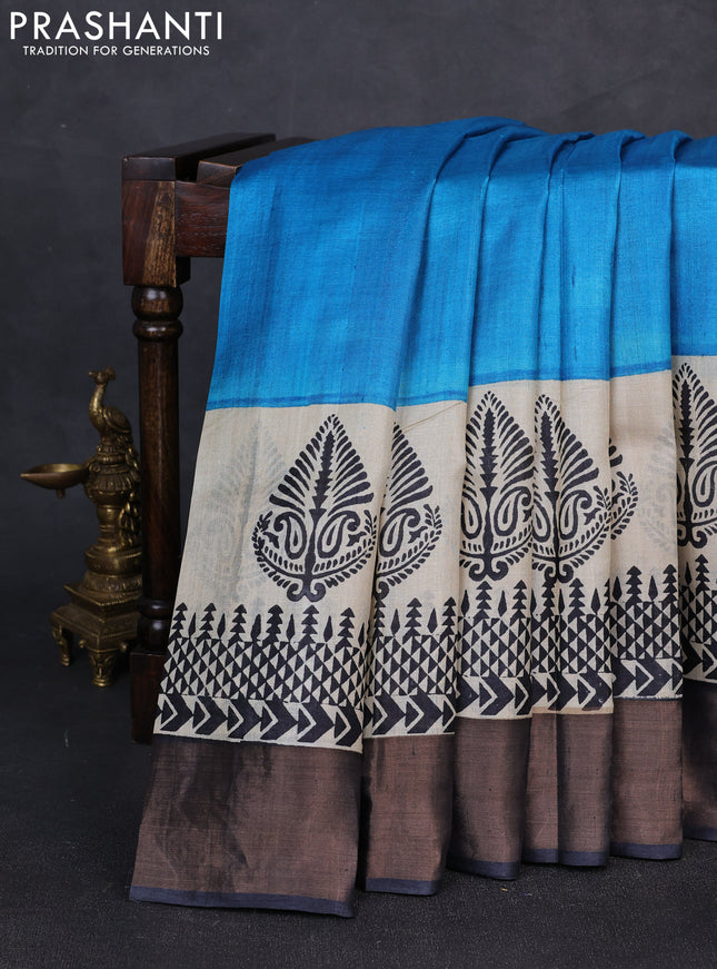Pure tussar silk saree cs blue and beige black with plain body and long printed zari woven border