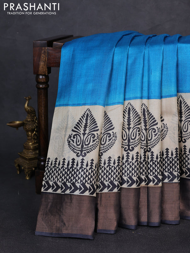 Pure tussar silk saree cs blue and beige black with plain body and long printed zari woven border