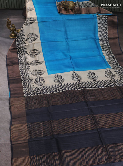 Pure tussar silk saree cs blue and beige black with plain body and long printed zari woven border