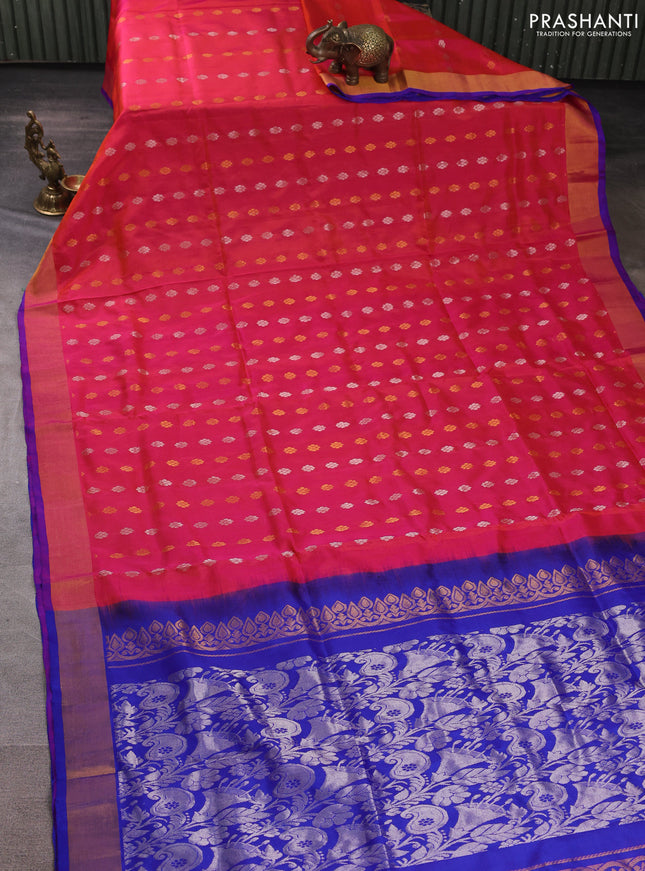 Pure uppada silk saree dual shade of pinkish orange and blue with allover silver & gold zari woven floral buttas and zari woven border