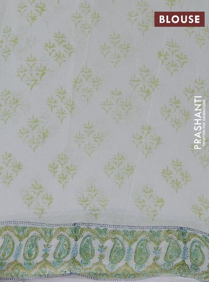 Georgette saree cream and lime green with allover block prints and printed border