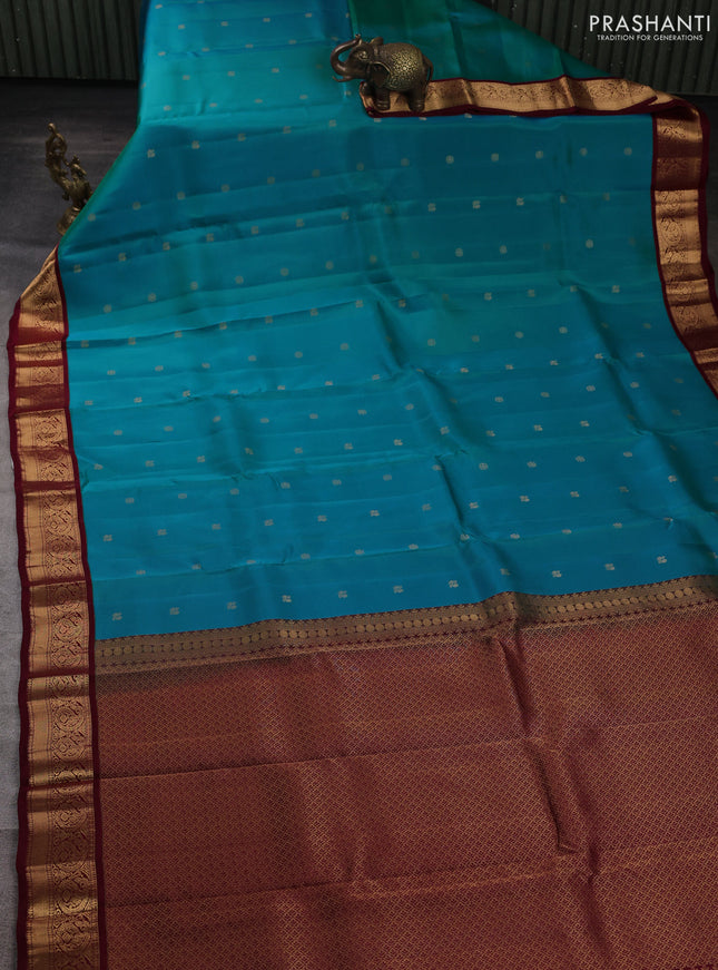 Kanchipuram silk saree dual shade of peacock green and maroon with allover zari woven buttas and zari woven border