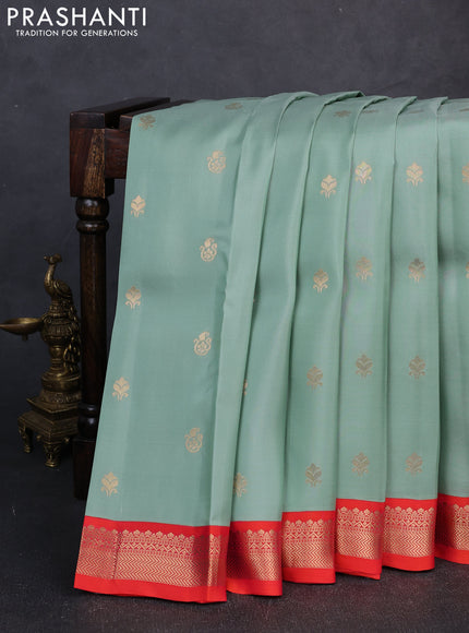 Kanchipuram silk saree pastel green and orange with allover zari woven buttas and zari woven border