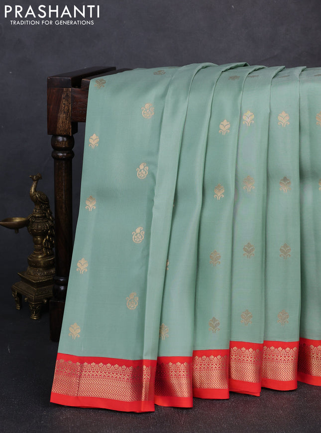 Kanchipuram silk saree pastel green and orange with allover zari woven buttas and zari woven border