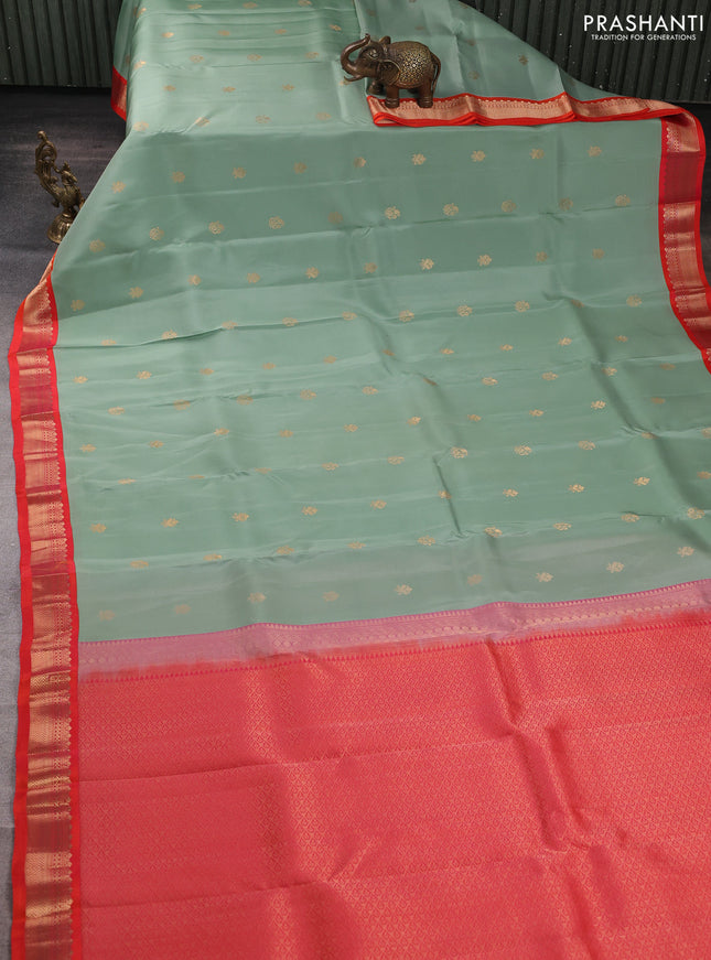 Kanchipuram silk saree pastel green and orange with allover zari woven buttas and zari woven border