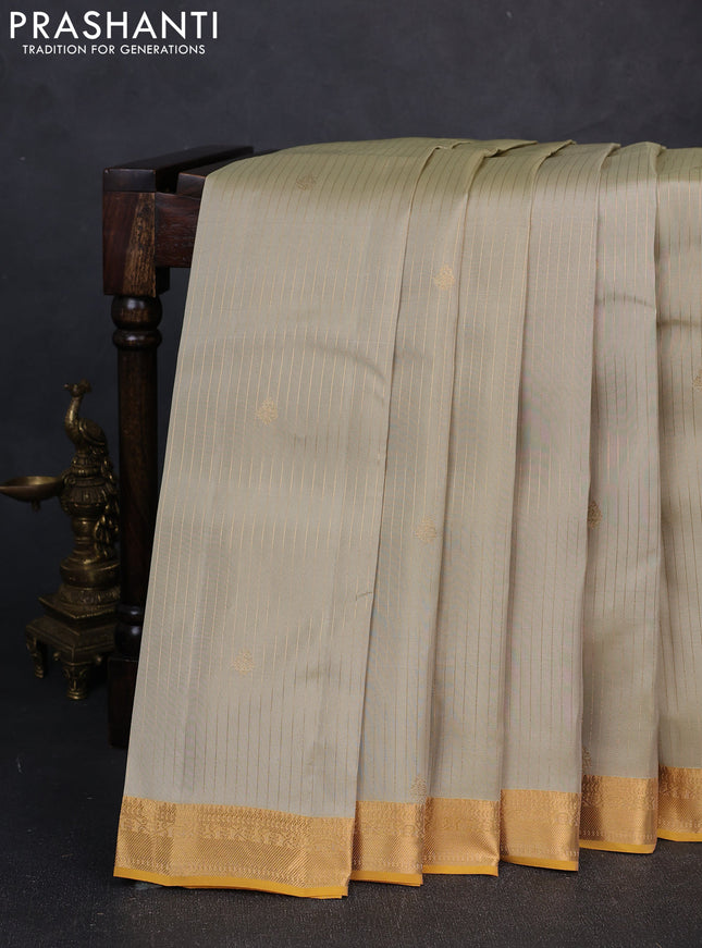 Kanchipuram silk saree mild pista green and mustard yellow with allover zari woven stripes & buttas and zari woven simple border