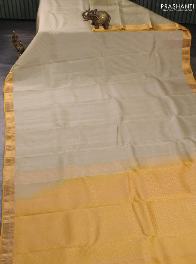 Kanchipuram silk saree mild pista green and mustard yellow with allover zari woven stripes & buttas and zari woven simple border