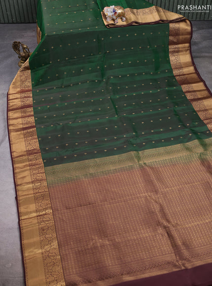 Kanchipuram silk saree bottle green and coffee brown with allover zari woven buttas and long rich zari woven border